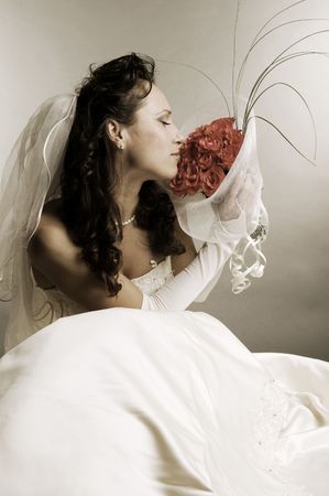 beautiful bride smelling the fragrance of rosesの写真素材
