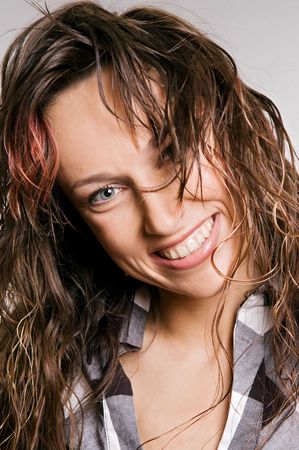 portrait of happy woman against grey backgroundの写真素材