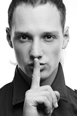 black and white portrait of handsome man hushing over whiteの写真素材