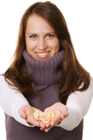 happy woman with pills in hands over whiteの写真素材