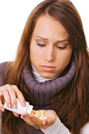 young woman with bottle of pills over whiteの写真素材