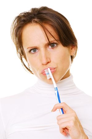 woman with toothbrush thinking. isolated on whiteの写真素材