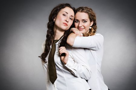 two schoolgirls over grey backgroundの写真素材