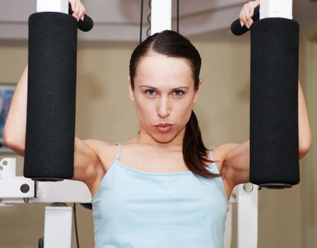 young woman doing exercises to develop muscles