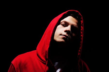 hip-hop man in red hood against black background の写真素材