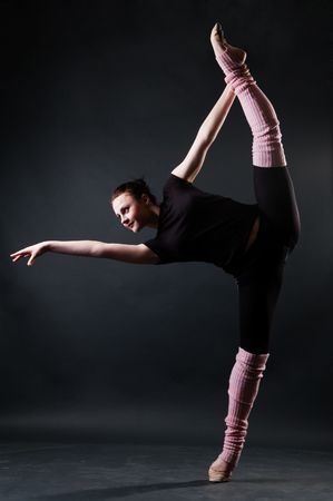 beautiful smiley ballerina against dark background