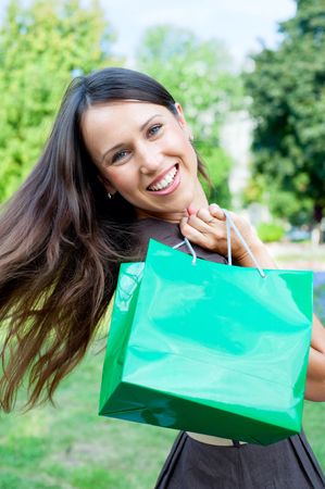 beautiful happy woman with green bagの写真素材