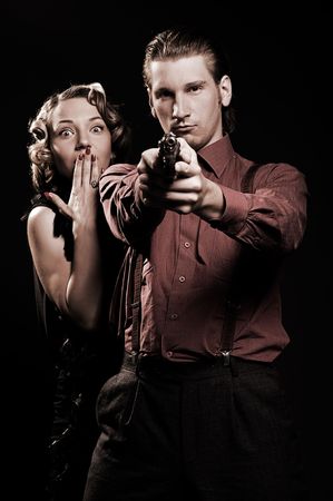 man with gun protecting his woman. retro portraitの写真素材