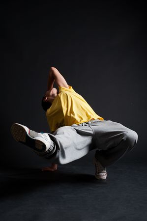 cool breakdancer in motion against dark backgroundの写真素材