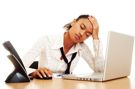 fatigued businesswoman with headache at the workplaceの写真素材
