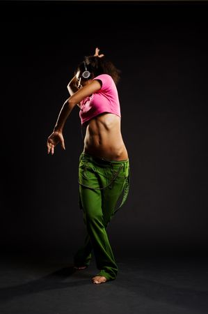 young beautiful woman listening music and dancing の写真素材