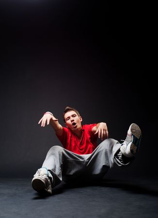 cool hip-hop guy sitting on the floorの写真素材