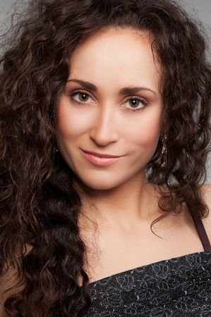 portrait of attractive smiley woman with curly hairの写真素材