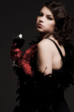 graceful woman holding glass of wine. retro portraitの写真素材