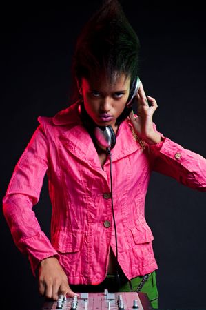 cool dj near the mixer in pink jacketの写真素材