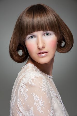 fashion portrait of woman with haircut over grey backgroundの写真素材