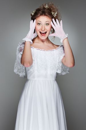 portrait of amazed beautiful woman in white dressの写真素材