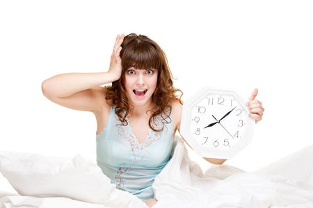 young startled woman with clock in panicの写真素材
