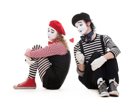 portrait of mimes. smiley man giving heart to sad woman. isolated on white backgroundの写真素材