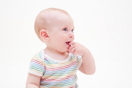 portrait of pretty smiley baby in striped t-shirtの写真素材