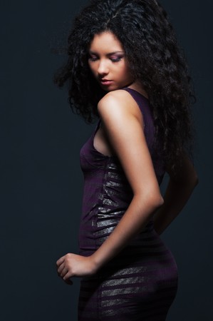 portrait of attractive woman in dress over dark background の写真素材