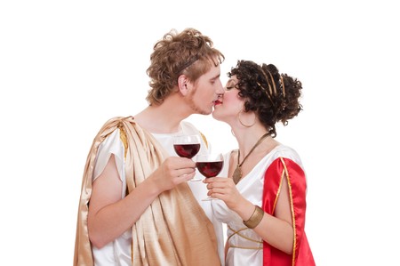 portrait of kissing couple with glasses of wine. greek styleの写真素材