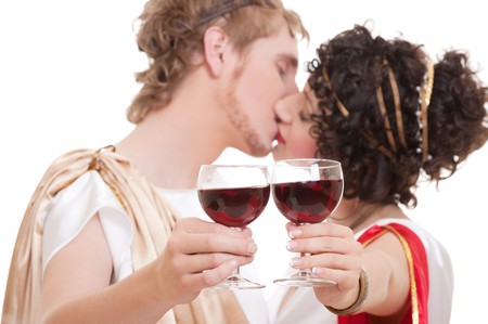 portrait of kissing couple with glasses of wineの写真素材