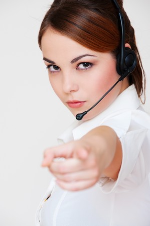 portrait of serious telephone operator over grey background の写真素材