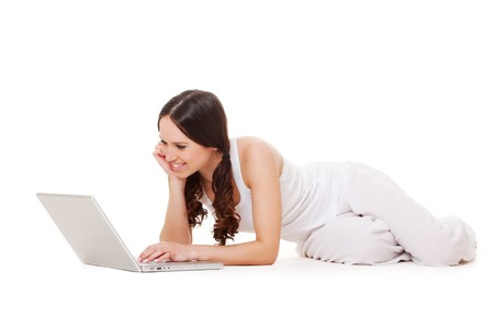 pretty young woman with laptop lying on the floor. isolated on white の写真素材