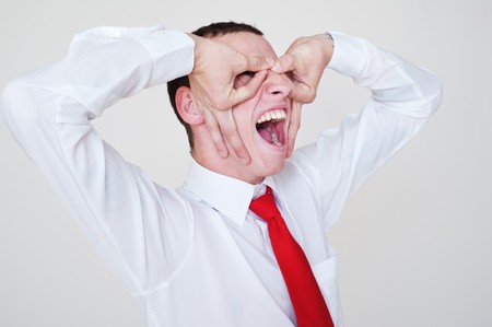 portrait of emotional businessman over grey backgroundの写真素材