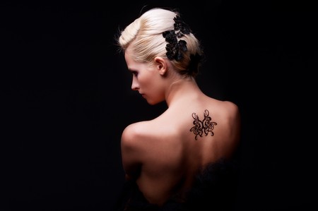 portrait of sexy woman with tattoo on her back