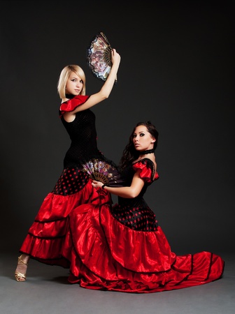 two sexy spanish dancers posing over dark background の写真素材