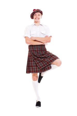happy scotch dancer in national clothes. isolated on white backgroundの写真素材
