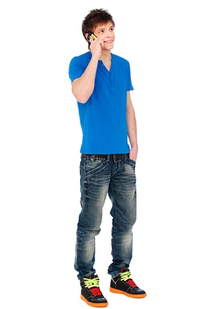 full-length portrait of young smiley man speaking on his mobile. isolated on white background
の写真素材