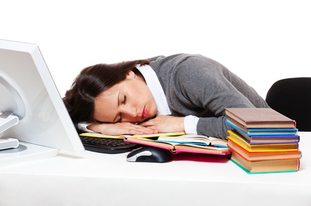 tired student sleeping on her workplace の写真素材
