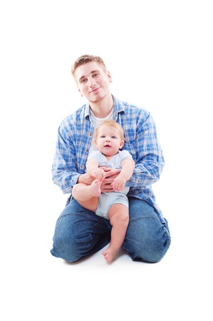 studio shot of father sitting with his son. isolated on whiteの写真素材