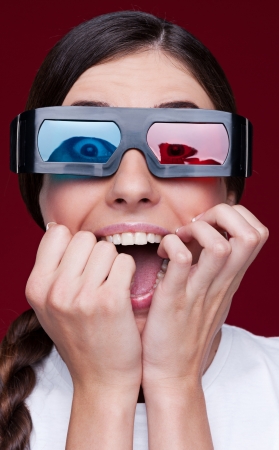 portrait of screaming woman in stereo glasses over red backgroundの写真素材