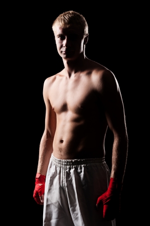 portrait of caucasian boxer with red bandage on hands. studio shot の写真素材