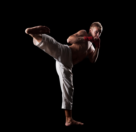 full-length portrait of fighter over black backgroundの写真素材