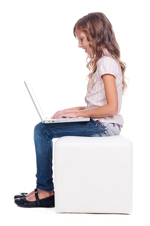 sideview of smiley girl with laptop. full length photo over white backgroundの写真素材
