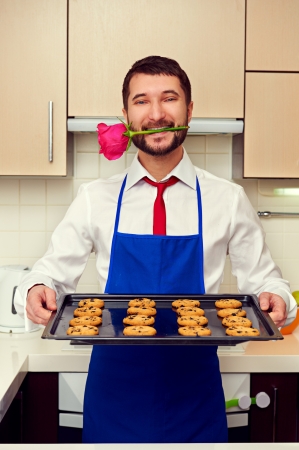 happy man had baked festive cookies for his womanの写真素材