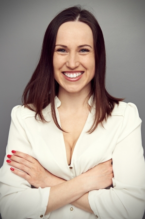 portrait of young attractive brunette over grey backgroundの写真素材