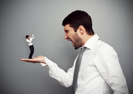 concept photo of big angry boss and small scared workerの写真素材