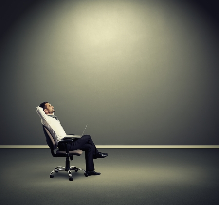 satisfied businessman resting on the chairの写真素材
