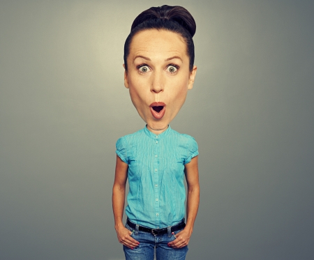 amazed woman with big head over grey background