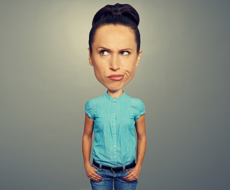 cartoon girl expressing dissatisfaction over grey backgroundの写真素材