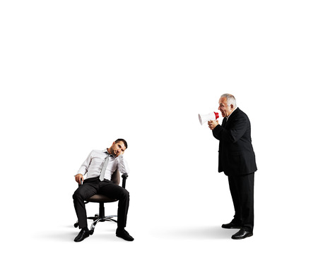 angry boss screaming at lazy worker. isolated on white backgroundの写真素材