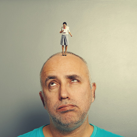 emotional businesswoman screaming at tired senior manの写真素材