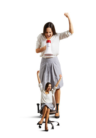 big businesswoman and small happy woman over white backgroundの写真素材