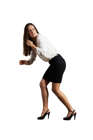 angry businesswoman pulling invisible rope. isolated on white backgroundの写真素材